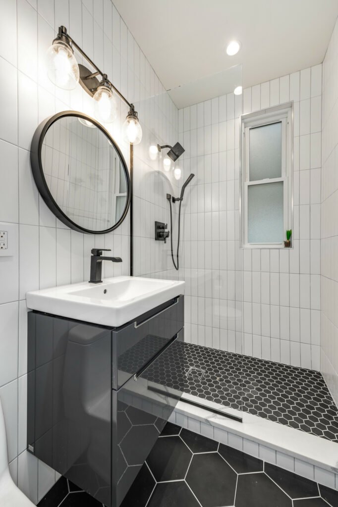 a tiled black and white bathroom
